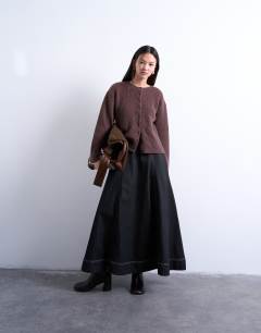 Model wearing Knitted easy ribbed relaxed cardigan in chocolate