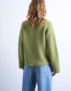 Model wearing Knitted easy ribbed relaxed cardigan in green