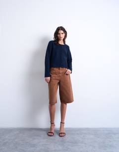 Model wearing Knitted easy ribbed relaxed cardigan in navy