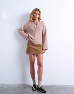 Model wearing Knitted easy ribbed relaxed cardigan in oat