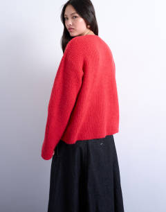 Model wearing Knitted easy ribbed relaxed cardigan in red