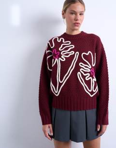 Model wearing Knitted embroidered floral jumper in burgundy 