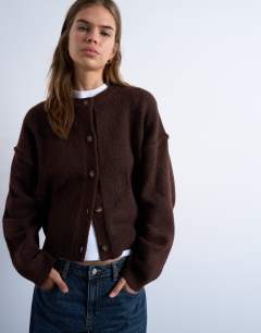 Model wearing Knitted exposed seam relaxed cardigan in brown