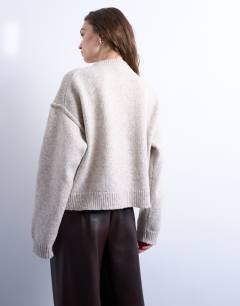 Model wearing Knitted exposed seam relaxed cardigan in oat