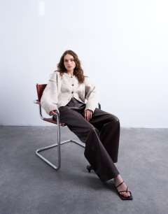 Model wearing Knitted exposed seam relaxed cardigan in oat