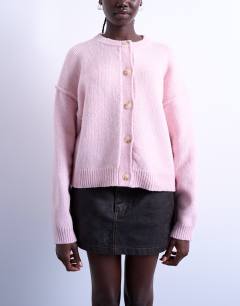 Model wearing Knitted exposed seam relaxed cardigan in pink