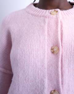 Model wearing Knitted exposed seam relaxed cardigan in pink