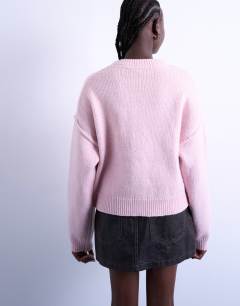 Model wearing Knitted exposed seam relaxed cardigan in pink
