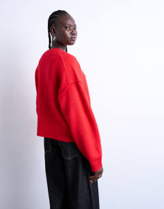 Model wearing Knitted exposed seam relaxed cardigan in red