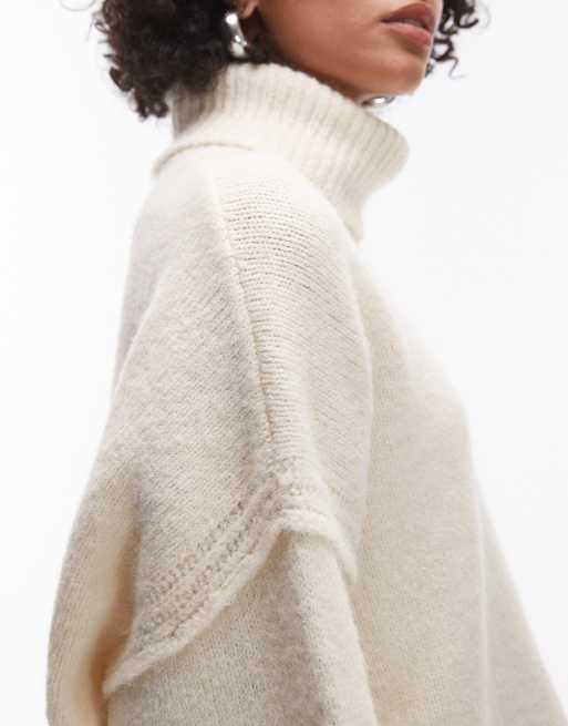 Topshop knitted exposed seam roll neck relaxed jumper in ivory ASOS