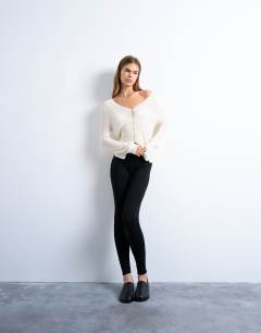 Model wearing Knitted fine rib cardigan in ivory