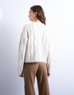 Model wearing Knitted fluffy cable cardigan in cream
