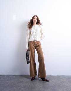 Model wearing Knitted fluffy cable cardigan in cream