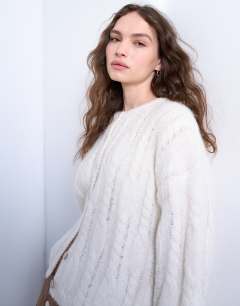 Model wearing Knitted fluffy cable cardigan in cream