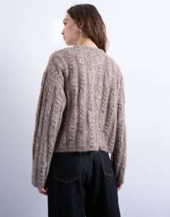 Model wearing Knitted fluffy cable cardigan in oat