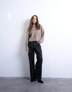 Model wearing Knitted fluffy cable cardigan in oat