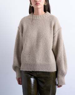 Model wearing Knitted fluffy exposed seam easy jumper in oat