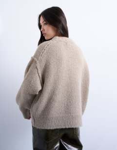 Model wearing Knitted fluffy exposed seam easy jumper in oat
