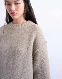 Model wearing Knitted fluffy exposed seam easy jumper in oat