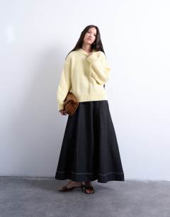 Model wearing Knitted fluffy exposed seam easy jumper in yellow
