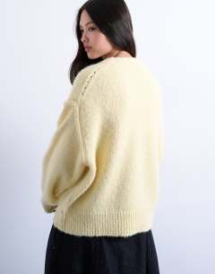 Model wearing Knitted fluffy exposed seam easy jumper in yellow
