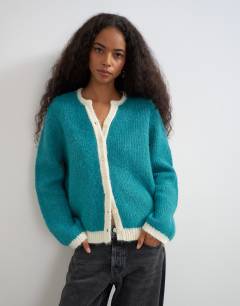 Model wearing Knitted fluffy eyelash cardigan in teal with tipping detail