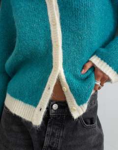 Model wearing Knitted fluffy eyelash cardigan in teal with tipping detail