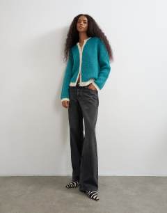 Model wearing Knitted fluffy eyelash cardigan in teal with tipping detail