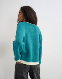 Model wearing Knitted fluffy eyelash cardigan in teal with tipping detail