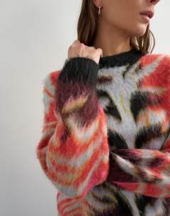 Model wearing Knitted fluffy relaxed fit brushed abstract crew neck jumper in red