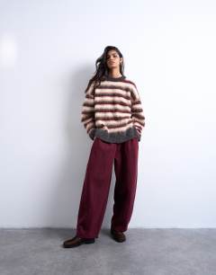 Model wearing Knitted fluffy stripe jumper in neutral and burgundy