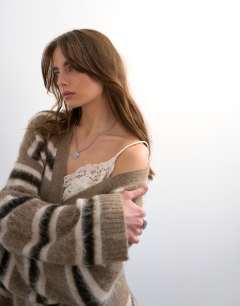 Model wearing Knitted fluffy stripe wrap tie cardigan in neutral