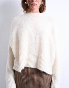 Model wearing Knitted fluffy ultimate jumper in cream 