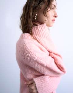 Model wearing Knitted fluffy ultimate jumper in pink