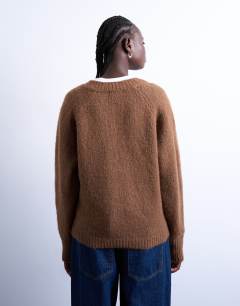 Model wearing Knitted fluffy v neck jumper in brown