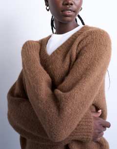 Model wearing Knitted fluffy v neck jumper in brown