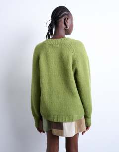 Model wearing Knitted fluffy v neck jumper in green