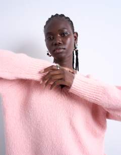 Model wearing Knitted fluffy v neck jumper in pink
