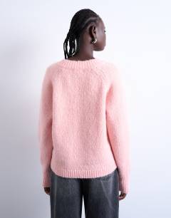 Model wearing Knitted fluffy v neck jumper in pink
