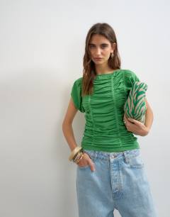Model wearing Knitted gathered detail cap sleeve top in green