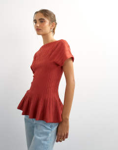 Model wearing Knitted grown on short sleeve peplum top in deep red