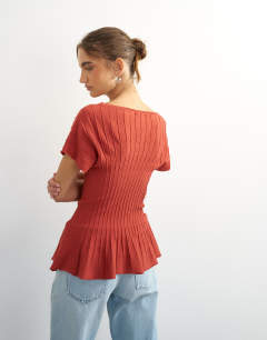 Model wearing Knitted grown on short sleeve peplum top in deep red