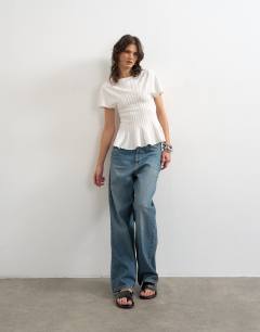 Model wearing Knitted grown on short sleeve peplum top in ivory