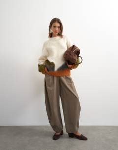Model wearing Knitted hairy abstract colour block stripe wool crew neck jumper in ivory multi