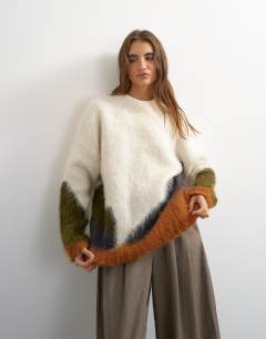 Model wearing Knitted hairy abstract colour block stripe wool crew neck jumper in ivory multi