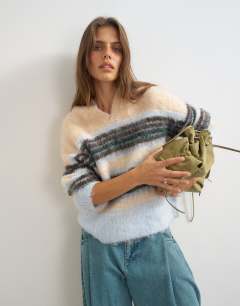 Model wearing Knitted hairy high v neck wool stripe jumper in neutral multi
