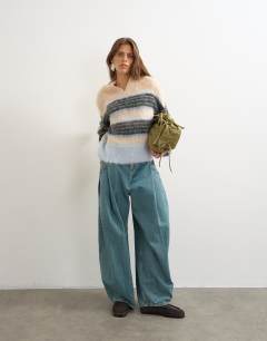 Model wearing Knitted hairy high v neck wool stripe jumper in neutral multi
