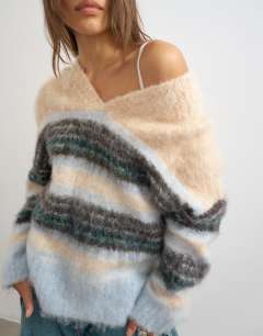 Model wearing Knitted hairy high v neck wool stripe jumper in neutral multi