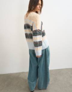 Model wearing Knitted hairy high v neck wool stripe jumper in neutral multi