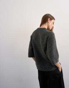 Model wearing Knitted half sleeve t-shirt in charcoal